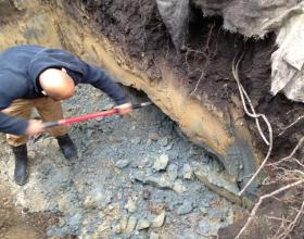 Hand digging seam of contaminated soil in Nanaimo BC