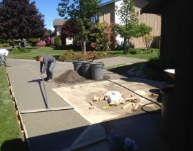 Finishing concrete driveway extension in Victoria BC