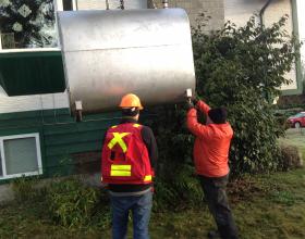 Inspecting oil tank for cause of leak in Duncan BC