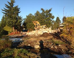 Excavator on demolished house in Victoria BC
