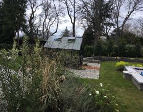 Landscape of backyard with lawn and greenhouse in Victoria