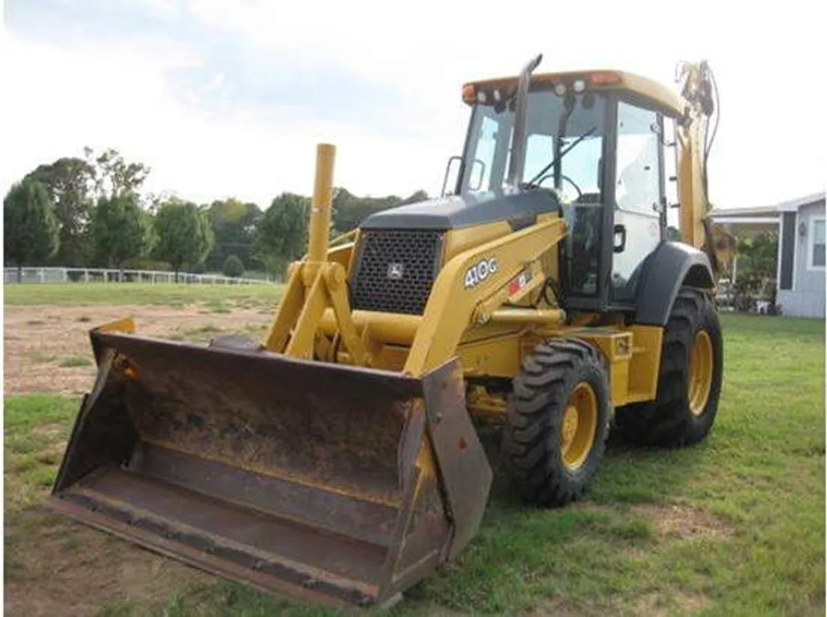Backhoe with four-in-one bucket and extendahoe