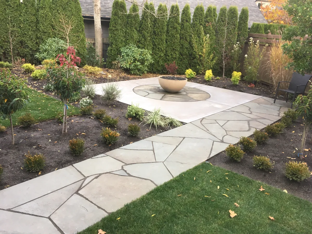 Finished concrete patio with slate sidewalk inset