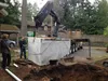 Thumbnail: Heavy equipment installing large concrete septic tank