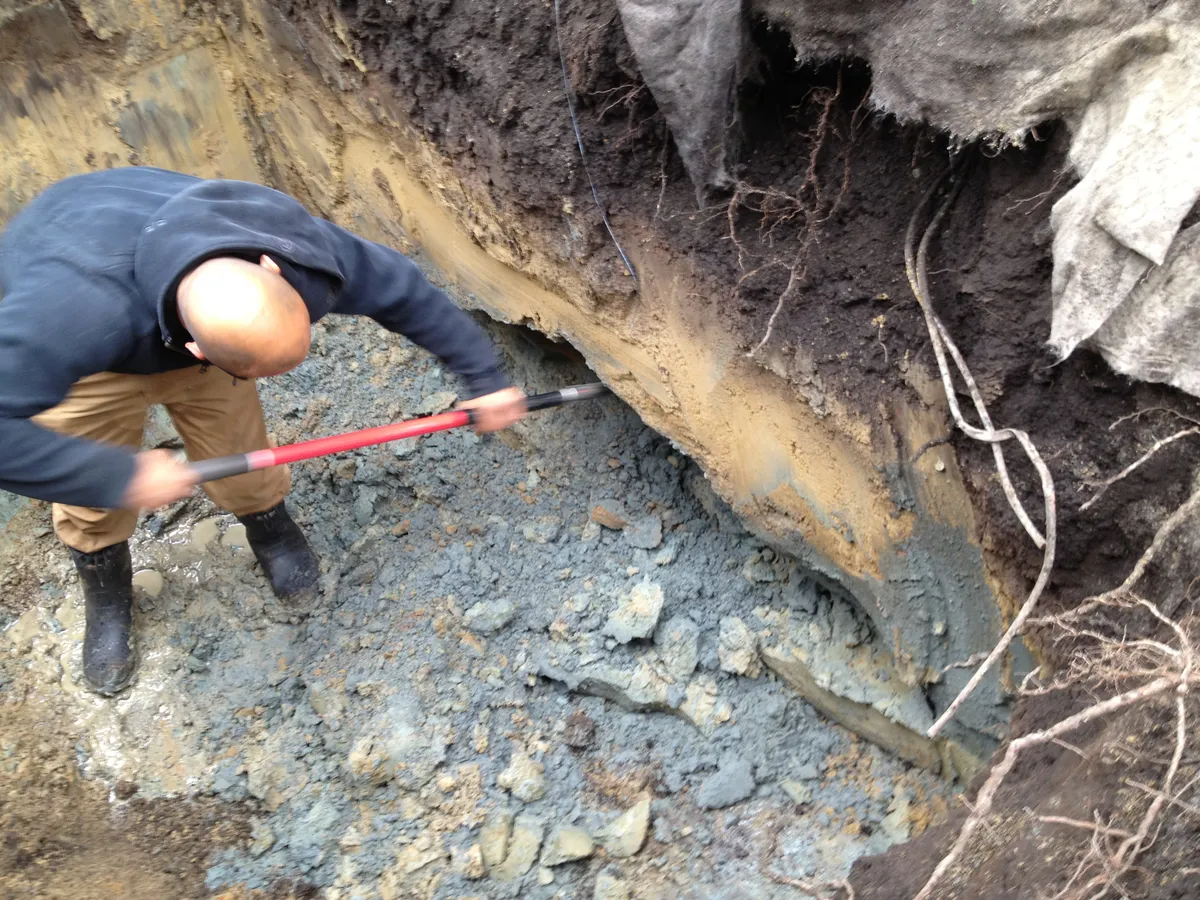 Hand excavation of contaminated soil at disaster site
