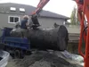 Thumbnail: Loading large oil tank onto transport truck