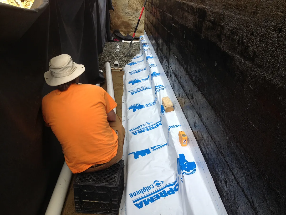 Perimeter drain tile installation and waterproofing