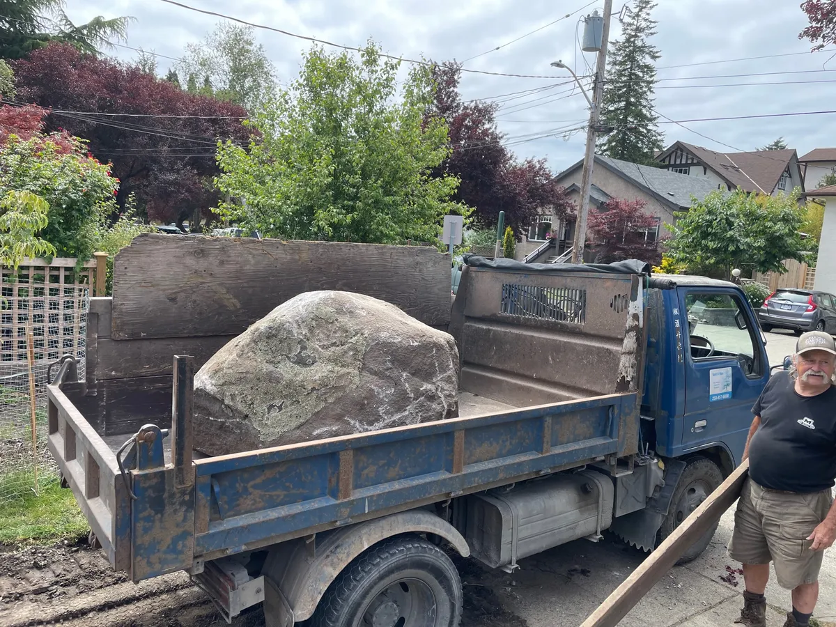 Truck hauling removed rock and debris