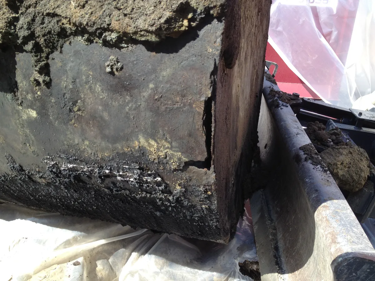 Severely rusted buried oil tank
