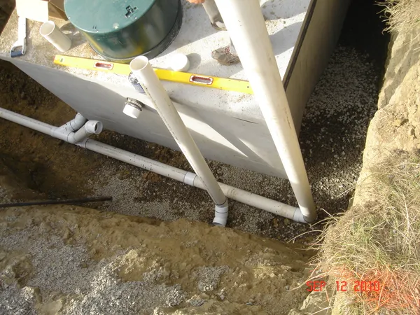 Concrete septic tank being installed underground