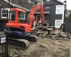 Excavator Removing Concrete and Asphalt