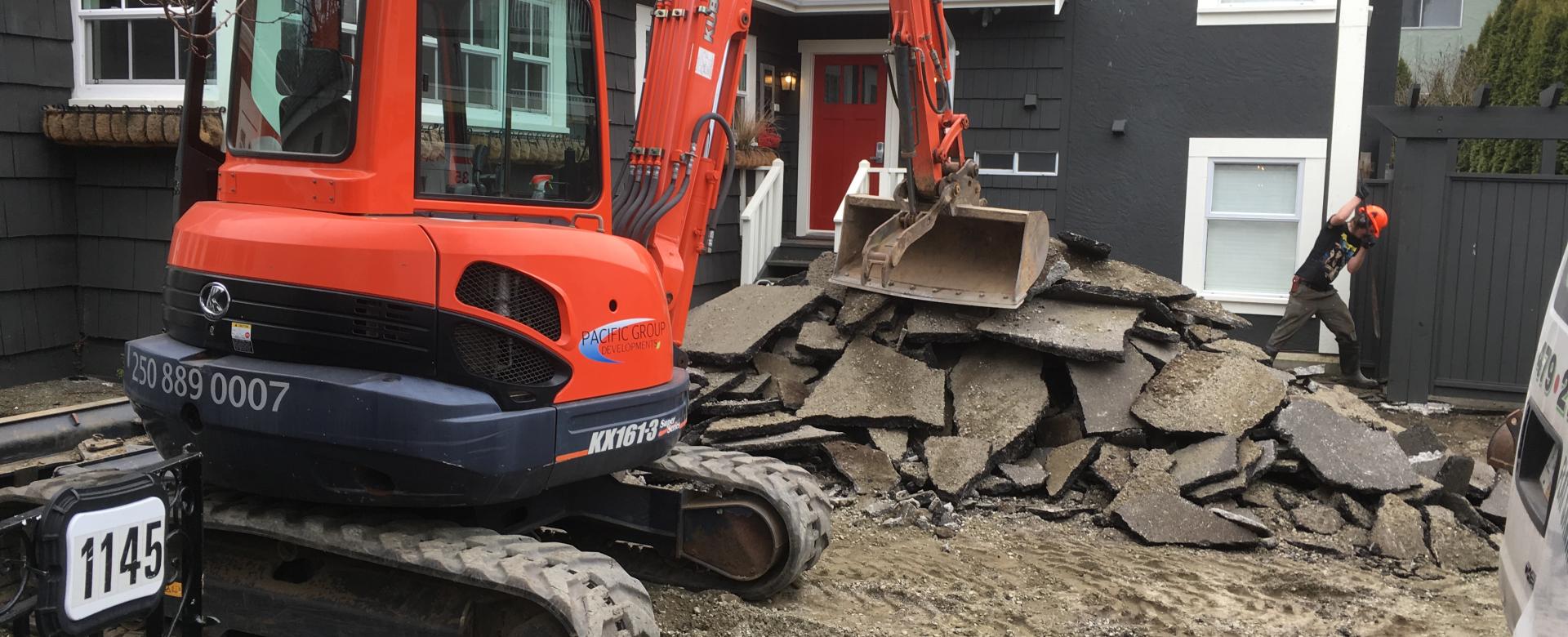 Excavator Removing Concrete and Asphalt